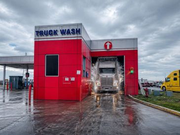 Truck being washed at a truck wash station.