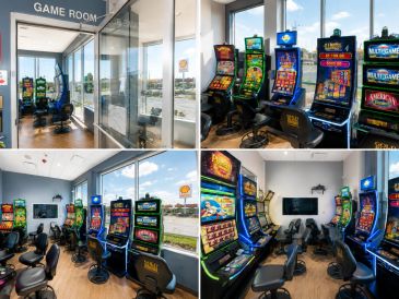 Arcade game room with slot machines and chairs.
