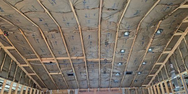 Ceiling insulation installed in a house under construction.