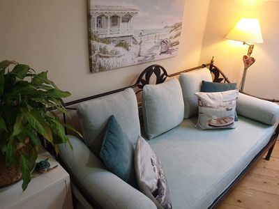 Therapy room with a sofa, plant, beach picture and light