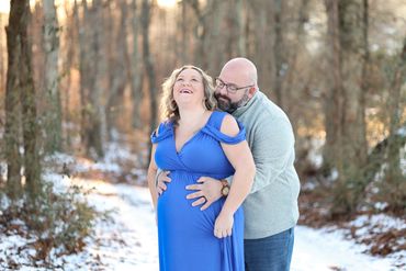 Photo of a couple on snow covered ground for a maternity photo session in Gatlinburg, TN. 