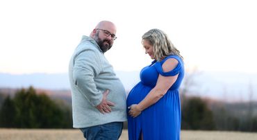 Photo of a couple on snow covered ground for a maternity photo session in Gatlinburg, TN. 