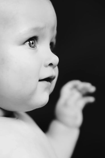 Black & white profile of baby up close showing eyes wide open