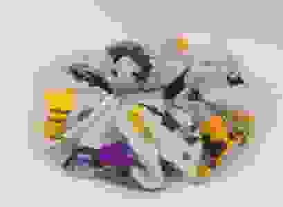 Gray scrunchie with Halloween sloths on it on a white background.