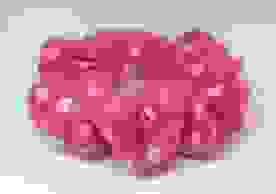 A pink scrunchie with light pink, yellow and orange dots on a white background.