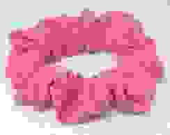 Adorable hot pink scrunchie placed on an all white background.