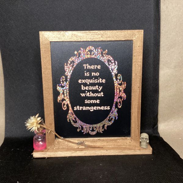 Decorated frame with strangeness quote