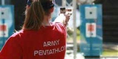 a woman wearing red t shirt is holding a gun 