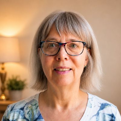 Smiling elderly woman with glasses.