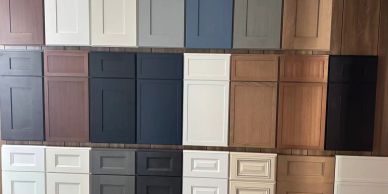 Various cabinet door samples in different colors and styles displayed on a wall.