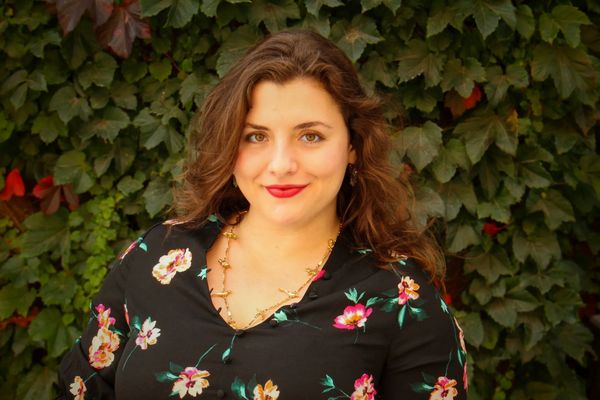 Photo of Hayli in front of an ivy wall