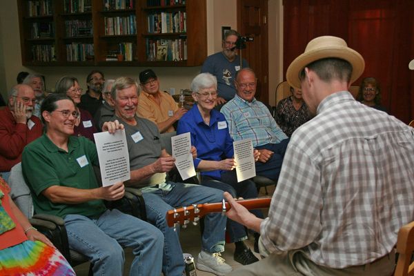 Todd Hoke gets some help from the audience at Arhaven House Concerts near Austin, TX