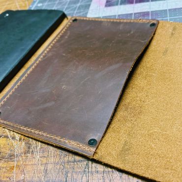 Brown leather wallet with stitching detail.