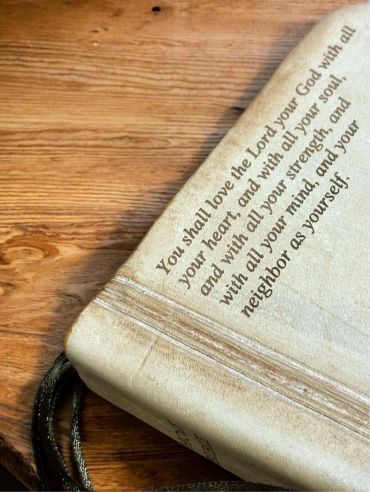 Bible with a scripture verse on the cover.