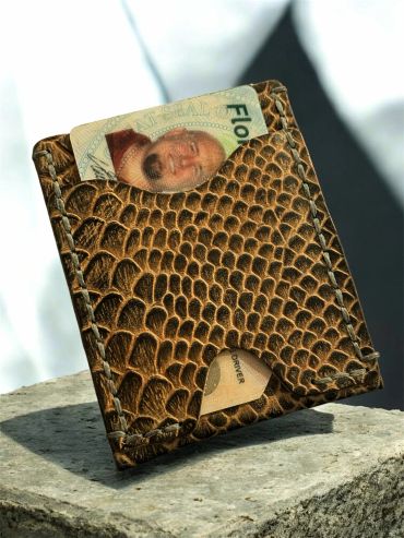 Brown textured leather wallet with cards partially visible inside.