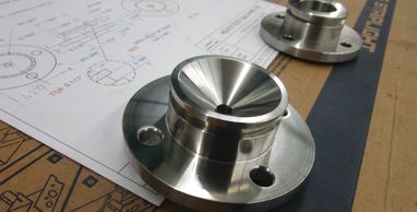 Custom part machined from type 316L Stainless with material certs., polished to a sanitary finish.