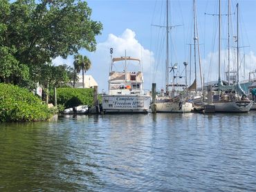 Boats docked at a marina on a sunny day.