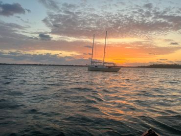 Sailboat on water at sunset.