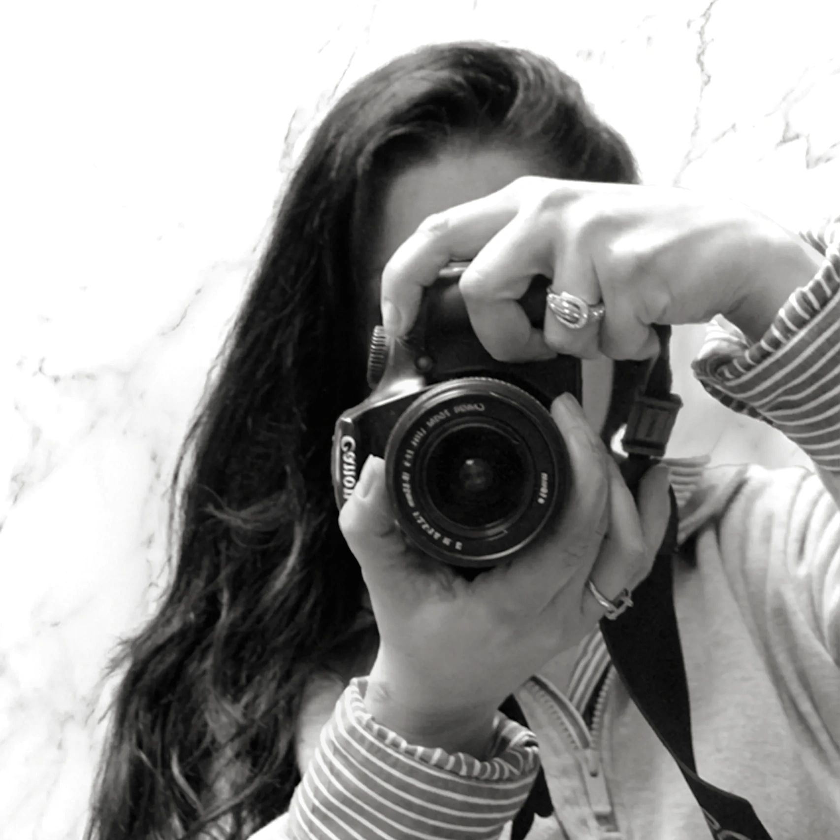 Person taking black and white photo with a Canon camera.
