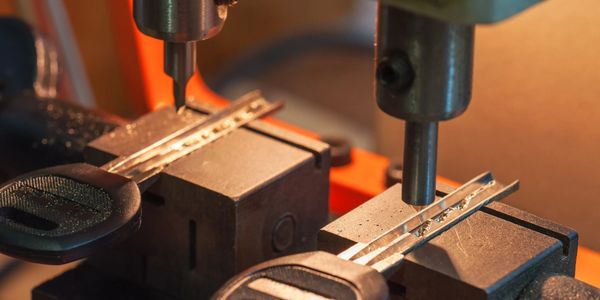 Close-up of a machine cutting keys from car key blanks.