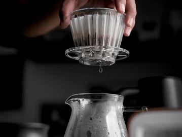 Hand pressing a coffee drip filter.