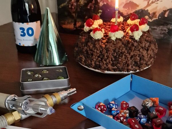 Birthday cake with single candle and dice.