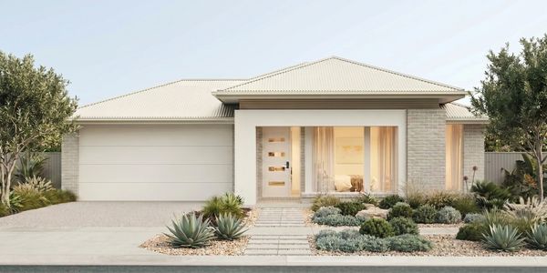 Modern single-story house with a large garage and desert landscaping.