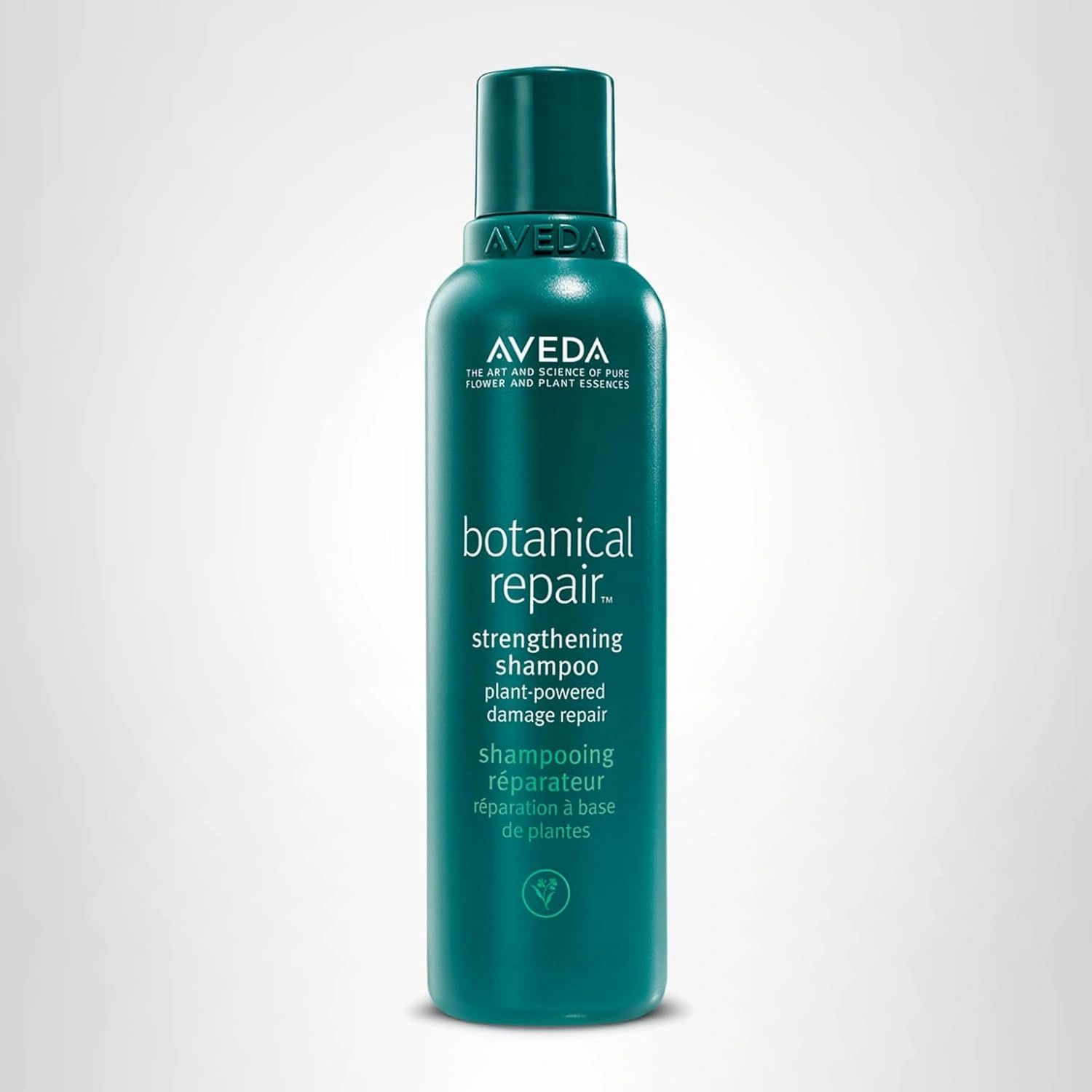 Aveda botanical repair strengthening shampoo bottle in teal color.
