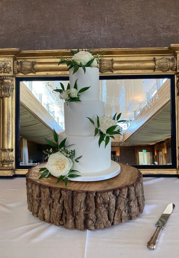 White fondant wedding cake with real white roses 