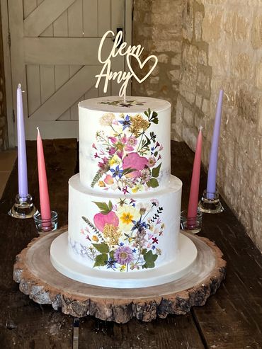 2 tiered semi-naked buttercream wedding cake with pressed edible flowers