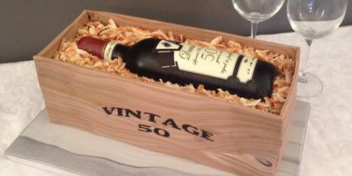 Sugar paste wine bottle, on a wooden crate birthday cake