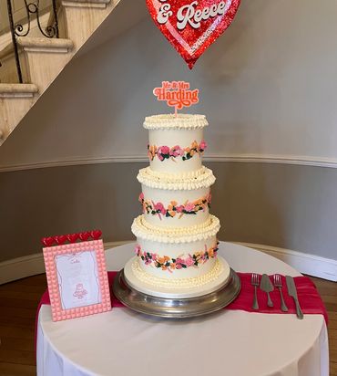 3 tiered wedding cake with piped buttercream flowers 