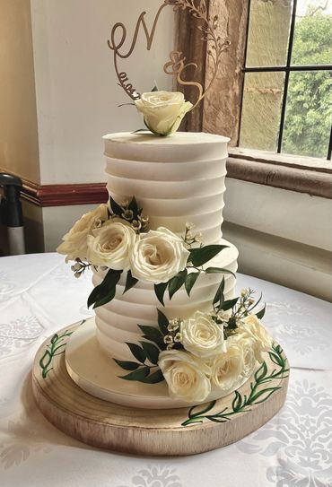 2 tiered wedding cake with white roses 