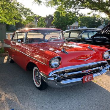 Classic red Chevrolet car parked outdoors.