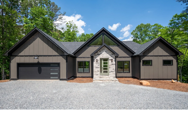 Custom contemporary home with 3 peaks, forward facing garage, limestone entry, and oversized windows