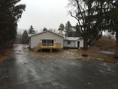 Addition with 4 panel vinyl slider,new deck and new vinyl siding. Added  for kitchen and dining room