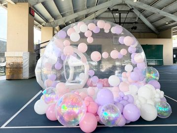 Clear inflatable dome filled with pastel balloons.