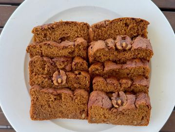 Sliced walnut banana bread on a white plate.