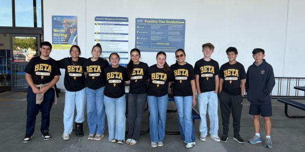 Group of students in BETA club shirts standing outdoors.