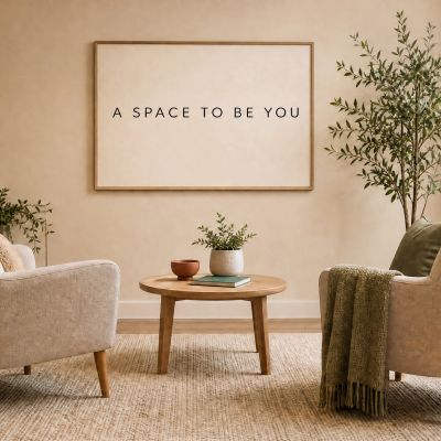 Cozy living room with two armchairs and a sign.