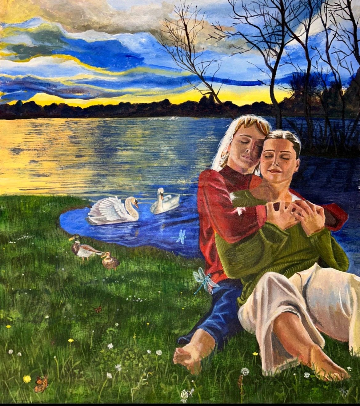 Couple embracing by a lake at sunset with swans and ducks nearby.