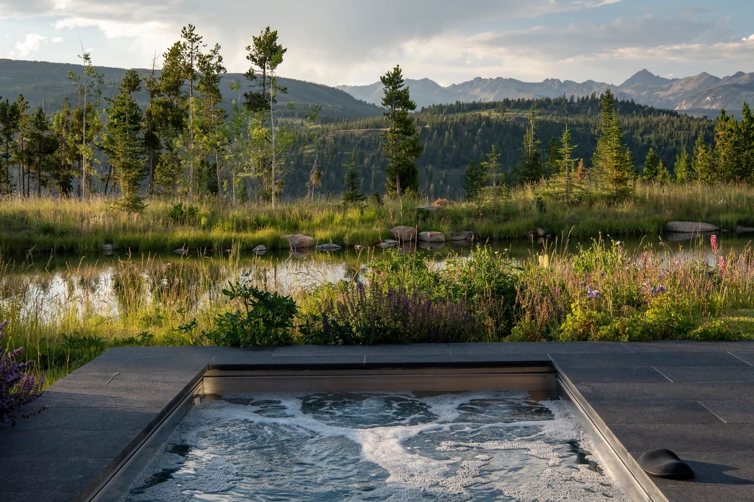 Hot tub overlooking a scenic mountain view.