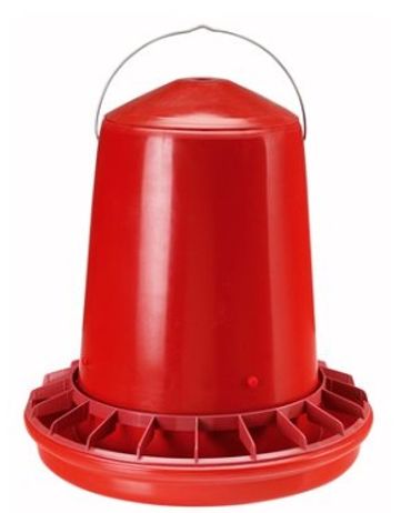 Red plastic poultry feeder with handle and multiple feeding slots.