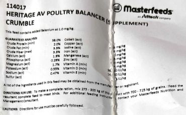 Close-up of a Heritage AV Poultry Balancer Supplement label with nutritional details.