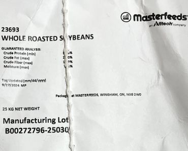 Package label of whole roasted soybeans from Masterfeeds with product details.