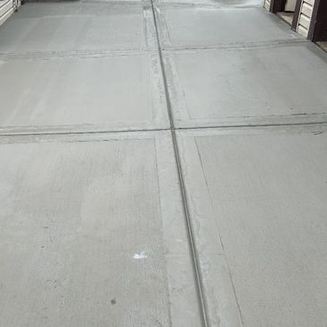 Freshly poured concrete sidewalk with joints.