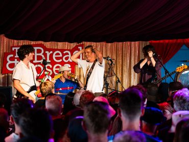Band performs live on stage at Break &amp; Pose event.