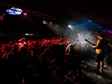 Band playing live in front of an energetic crowd.