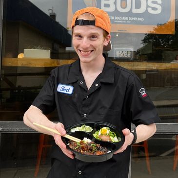 Chef Bret Whartenby, a Johnson & Wales grad, holding a short rib combo box.  