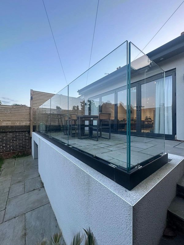 Glass balustrade to patio and 4 pane bifold to rear extension.